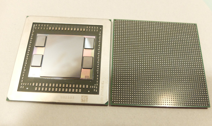 Внутренности корпуса графического ускорителя AMD Fiji. Центральный кристалл – собственно вычислитель, по обеим сторонам – упакованные в несколько слоев чипы HBM DRAM.