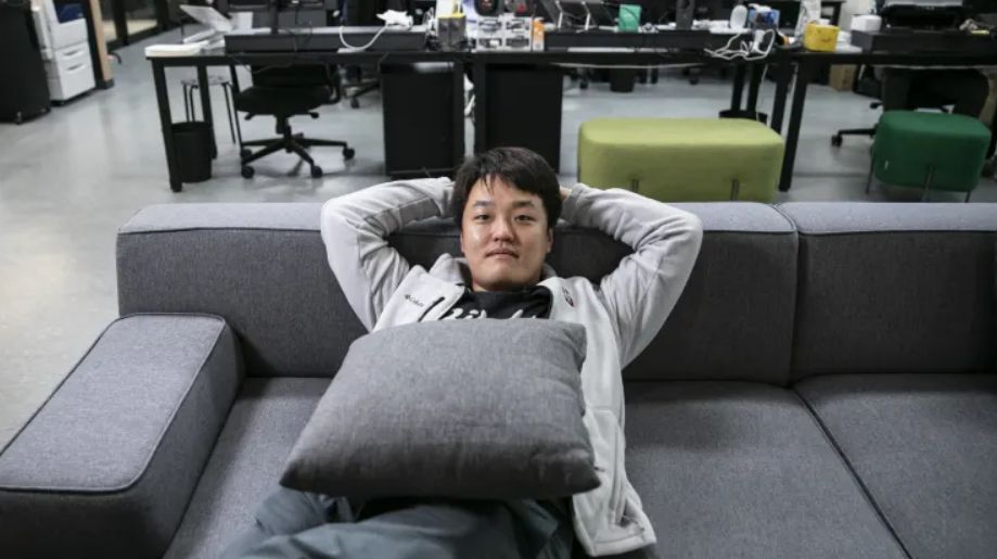 На этом фото До Квон, похоже, пытается замаскироваться под предмет мебели, чтобы избежать длинных щупалец Интерпола [Фото: Woohae Cho / Bloomberg / Getty Images]