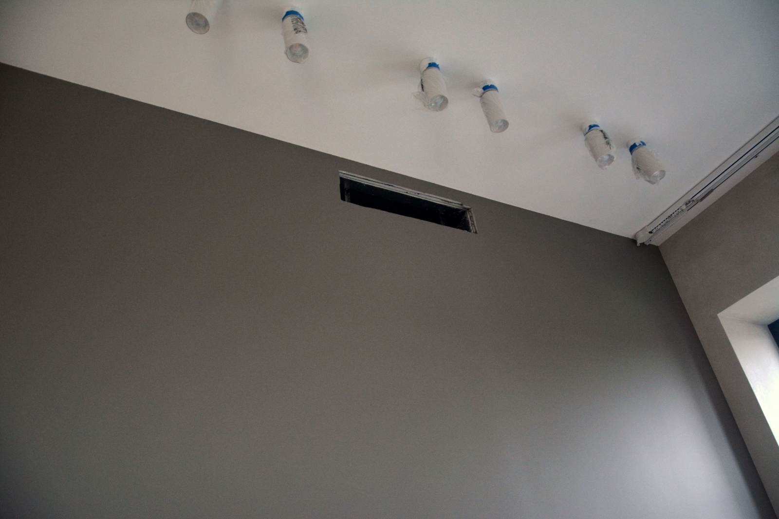 Светильники и прямоугольное отверстие канального кондиционера, пока без решетки. Дизайнер задумал здесь картины, которые будут красиво смотреться благодаря направленной подсветке Светильники и прямоугольное отверстие канального кондиционера, пока без решетки. Дизайнер задумал здесь картины, которые будут красиво смотреться благодаря направленной подсветке