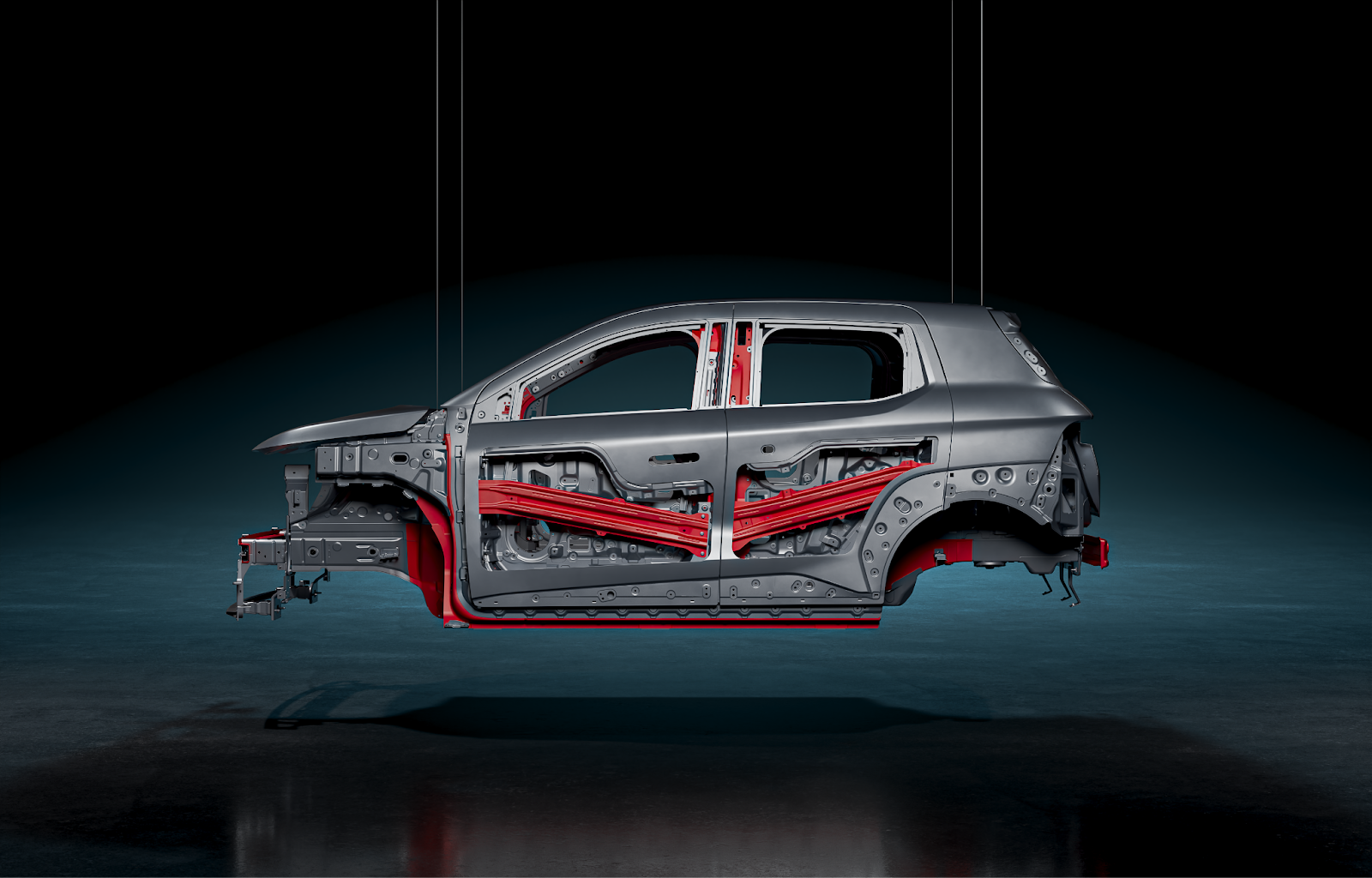 Кузов Атома, вид сбоку. Красным цветом отмечены элементы горячей штамповки Кузов Атома, вид сбоку. Красным цветом отмечены элементы горячей штамповки