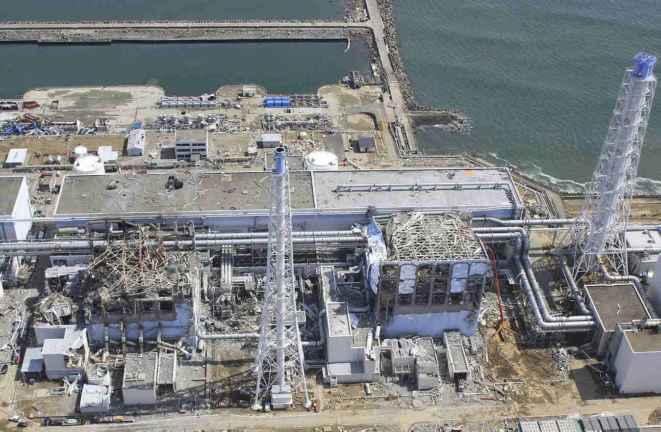 A drone captured this view of the damaged Unit 3 (left) and Unit 4 reactor buildings at the Fukushima Daiichi nuclear power plant on March 24, 2011, 13 days after the nuclear disaster. <span class="feature_caption_credit">Air Photo Service</span>