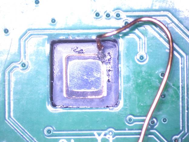 Backside-decapsulated RP2350 mounted on the analysis daughterboard